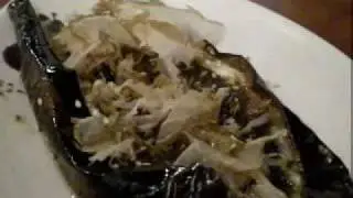 Creepy wriggling fish flakes on eggplant