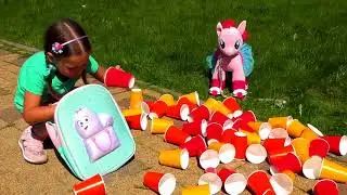 Sofia Plays With Colored Cups and Ride On Сhildren's Сar