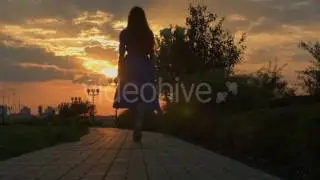 Girl Walking Away Through Park At The Sunset | Stock Footage - Videohive