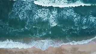 Aerial view of sand beach  Top view sea waves  Drone footage