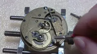 Checking out pocket watch movement, E. Howard