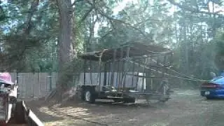 Tearing the roof off burned out cargo trailer