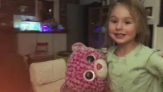 Little Girl grooming her stuffed animals