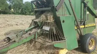 John Deere 3130 working a 410 belt baler