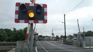 Portadown bound train travelling through Poyntzpass level crossing and railway station on 26.8.2024