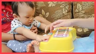 Baby is Playing a Toy Piano