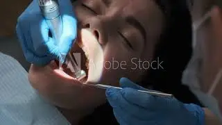 Dentist drilling the tooth of a pretty girl