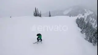 Man Trekking Up Steep Mountain Ski Touring In Winter Storm | Stock Footage - Envato elements