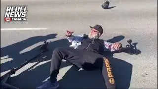 A Zionist from the HATEFUL crowd pushes an innocent man off his scooter INFRONT OF THE COPS