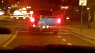 Drunk Man Hanging off the back of a Truck