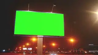 A Billboard With a Green Screen On a Streets