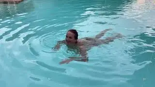 funny woman in the pool fooling around and getting high having water fun