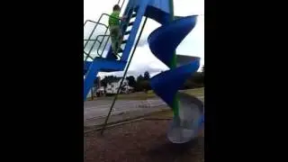 Boy goes down large slide