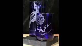 two blue glasses from beer bottles feather and dandelion