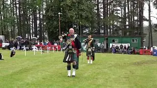 Drum Major Mace throw over banner competition at 2019 Tomintoul Highland Games in Moray Scotland