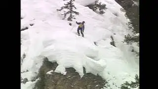 Skier Contemplates Jumping Off Cliff and Jumps