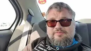 Man sits in car, in The Netherlands, talks a bit