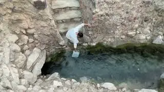 Abdul Wali, filling water from Ummul Ayaal spring