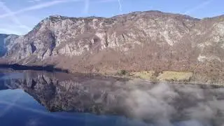 Bohinj Lake. 27 Dec. 2023. Ultimate footage over the lake. Clean mirror water. 4k Drone video.