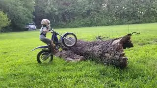 8 year old slays 3 foot tall trunk on trials bike.