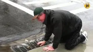 Pacific Grove resident Jerry Nelson removes debris from a storm drain to reduce flooding on Lighthou