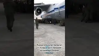 Rusiya ordusunun hərbçiləri İl-76 təyyarəsini itələyərək işə salmağa çalışırlar