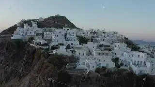 Aerial perspective over typically Greek Village Small Town on Island in Sunset Golden Hour Light