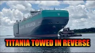 M/V Titania ship being towed stern first out the Port of Brunswick by Moran Tugs