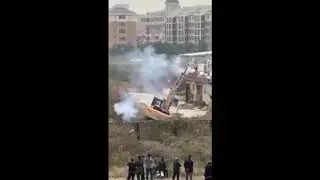Chinese protesting piled up excavator shooting it out of fireworks