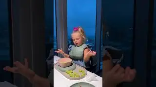 Забавная Наоми играет с виноградом за столом