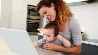 Mother Sitting with Baby Boy on Lap Using Laptop and Talking on Phone | Stock Footage - Videohive