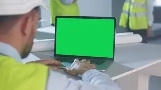 Engineer Using Laptop Computer with Green Screen Inside Building Under Construction | Stock Footage