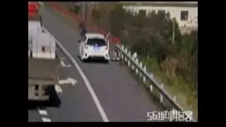 Man on shoulder hit off road by rolling wheel falling off truck HD