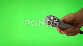 holding mic isolated green screen