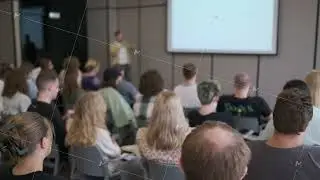 Audience listens to a speaker at a professional business presentation