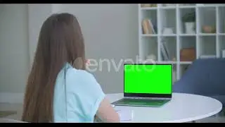 Woman Sits at Desk in Bedroom, She Looks at Laptop Green Screen and Talks To Someone Over Intern...