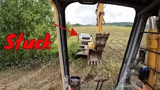 Case 140 Excavator put to the test cutting some crazy Brush because Aaron is stuck in the mud!