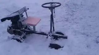 Mini tractor from mole driving on snow