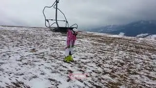 Kid hangs from ski lift by hood of jacket