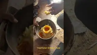 Eating a traditional Eritrean dish called gaat.   
