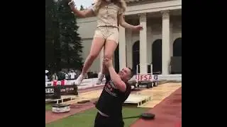 one arm lifts girl overhead