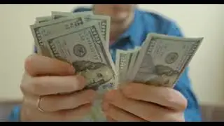 zoom, skype, meet, and background person counts 100 dollar banknotes in hands white background