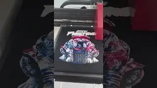 A3 DTG printer printing black t-shirt