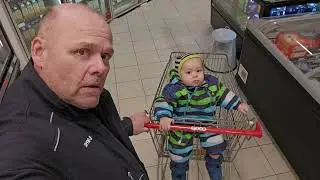 Simon sitting in a shopping cart for the first time 14 months old