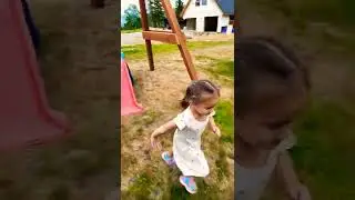 CUTE 3 YEAR OLD GIRL RUNNING AND PLAYING IN THE PLAYGROUND 