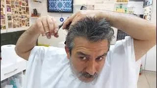 MUNUR ONKAN, THE WINNER OF TURKEY IN HAIR CUTTING, SHAVES HIMSELF