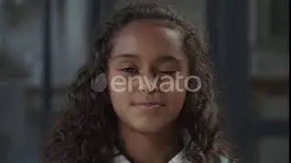 Charming Little Girl with Playful Smile Flirting | Stock Footage - Envato elements