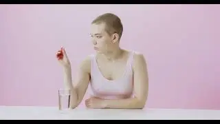 Young woman taking medicine...