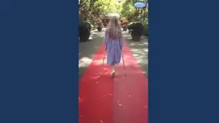 Beautiful amputee girl crutching on red carpet