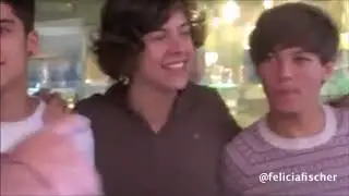 Louis pushing Zayn's hand from Harry's waist